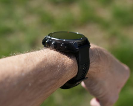 The side buttons of a Garmin Fenix 8 Pro pictured on a male wrist.