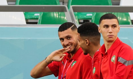 Morocco's midfielder Selim Amallah (L), Morocco's midfielder Bilal el Khannous (R) and teammates walk on the pitch before the start of the game against Spain.
