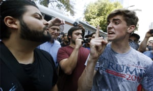 Wet Trump supporter argues with a protester.