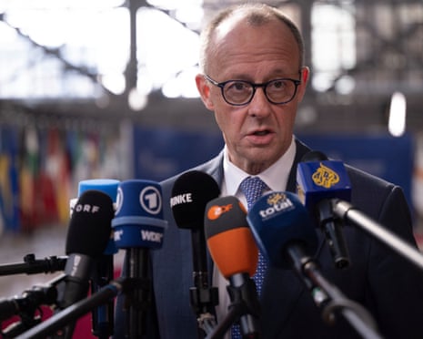 Germany's chancellor Friedrich Merz speaks to journalists as he arrives for a EU Summit at the EU headquarters in Brussels.