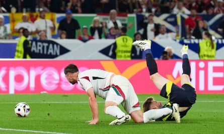 Scotland’s Stuart Armstrong is brought down by Hungary’s Willi Orban.