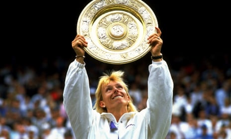 Martina Navratilova holds up the golden winners' plate after winning Wimbledon in July 1990