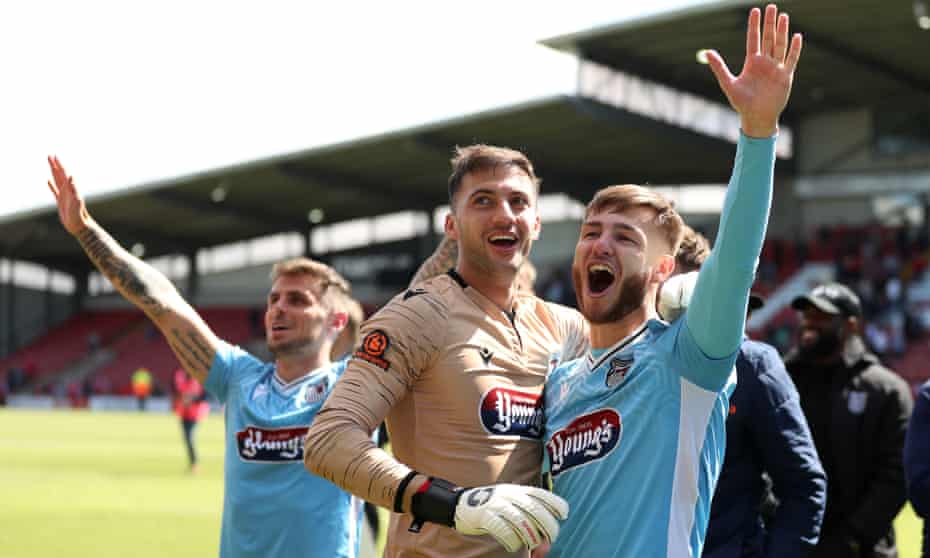 Grimsby’s John McAtee (right) celebrates with Max Crocombe and their teammates as they beat Wrexham 5-4 in the National League semi-final.