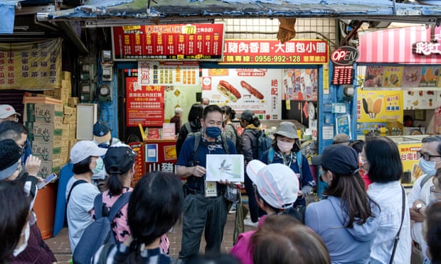 A crowd around a man holding a picture of a firefly