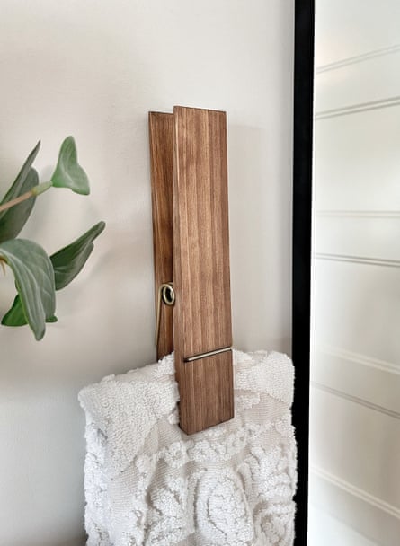 A product photo of a giant clothespin towel holder