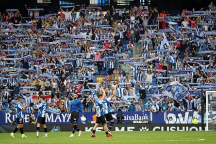 Espanyol players celebrate a famous win in front of their fans.