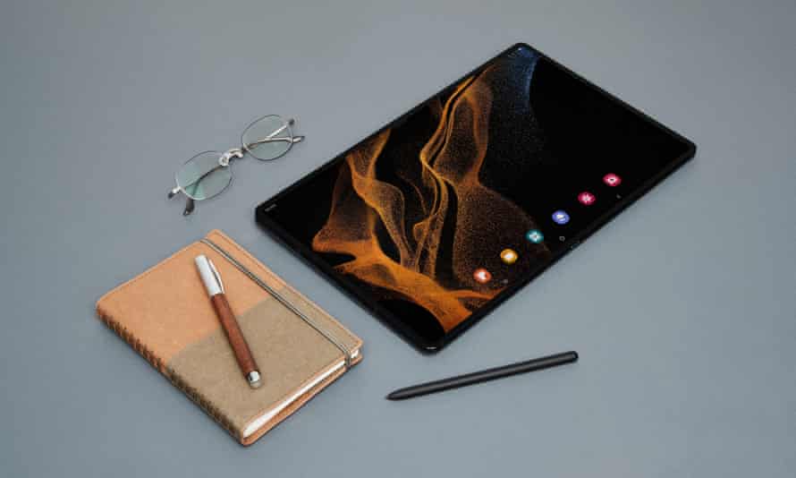 Samsung Galaxy Tab S8 Ultra shown next to a notebook, pen, stylus and glasses