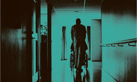 Nurse pushing wheelchair down corridor