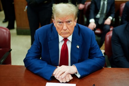 Donald Trump wears his usual bright blue suit and overlong red tie combo as he sits in court