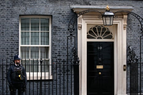 A police officer stands outside the door of 10 Downing Street on 9 February.