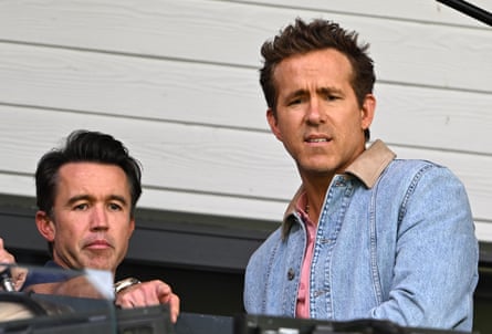 Wrexham co-owners Rob McElhenney and Ryan Reynolds watch from nan stand.