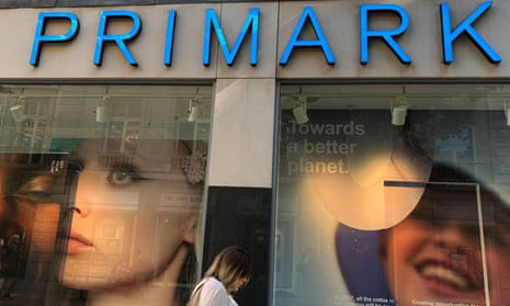 A woman walks passes a Primark store