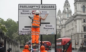 Greenpeace activists replace the destinations on the road signs around Westminster to read ‘Green Recovery’.