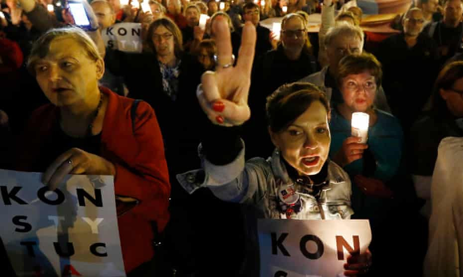 People protest against the reforms outside the supreme court in Warsaw on Tuesday.