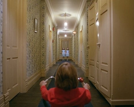 Danny on his trike with the twins at the end of the corridor