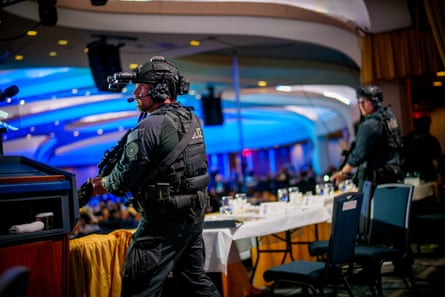 Armed Secret Service agents stand on stage during a shooting incident at the annual White House press dinner at the Washington Hilton.