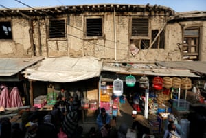 ‘I have a mental problem and doctors advised me to keep birds,’ says trader Mohammad Zahir Tanha in his shop, stacked with cages