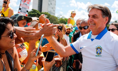 Jair Bolsonaro greets supporters in Brasilia.