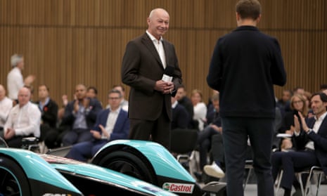 Thierry Bolloré smiling as a seated audience clap at a Jaguar Racing launch event