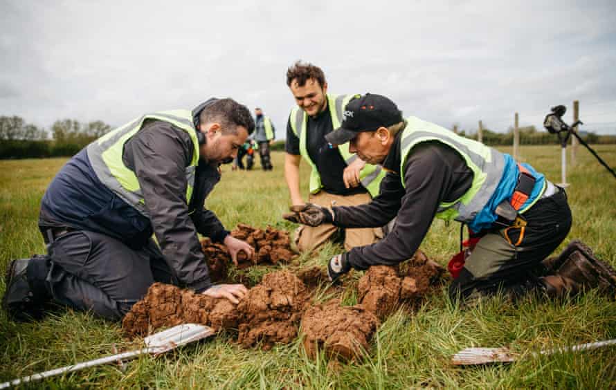 Cameron Jones, Antony Blakemore and Chris White excavate an unusually large hole with the permission of the landowner because they are detecting disparate signals across a wide area. Excitement spreads that there is the possibility of uncovering a hoard.