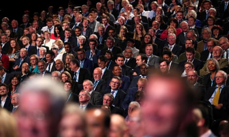 Delegates listen to Britain’s Prime Minister Theresa May as she addresses the Conservative Party conference in Manchester.