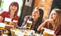 Happy girlfriends women group drinking beer at brewery bar restaurant - Friendship concept with young female friends enjoying time and having genuine fun at cool vintage pub - Focus on left girl
