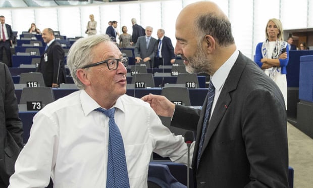 Jean-Claude Juncker, left, talks to Pierre Moscovici before delivering his state of the union address at the European parliament.