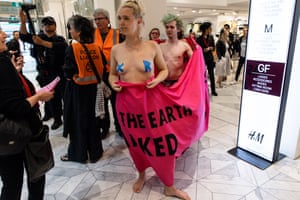 Activists wrapped in a banner demonstrate at an H&M store during an Extinction Rebellion protest in Melbourne, Australia