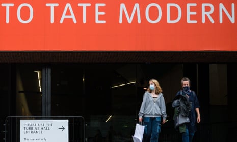 Visitors wearing protective face masks as they leave the Tate Modern gallery in London. It reopened today along with Tate Britain, Tate Liverpool and Tate St Ives.