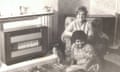 Katy Massey and her mother sitting by a gas fire, with a cat