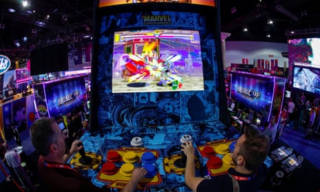 Attendees play a video game at E3 in Los Angeles in 2019