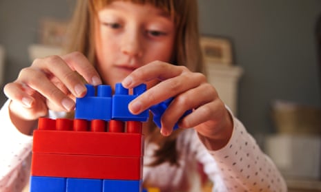 A girl playing with building blocks