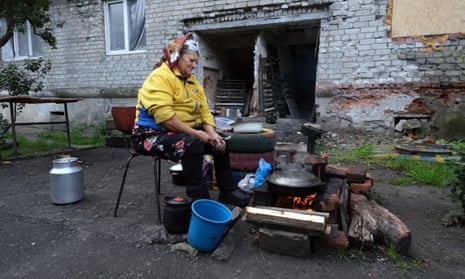 A woman cooks on the street in Lyman.