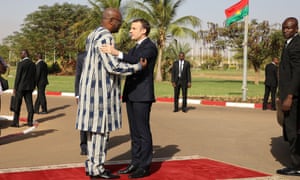 President Roch Marc Christian Kabore welcomes Emmanuel Macron to the presidential palace in Burkina Faso.