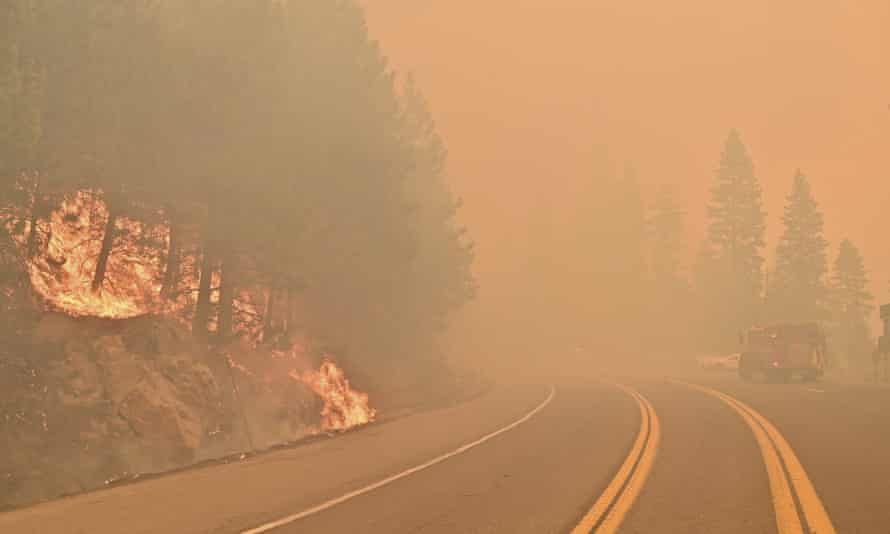 The Caldor fire burns on both sides of Highway 50, about 10 miles east of Kyburz, California, on Thursday.