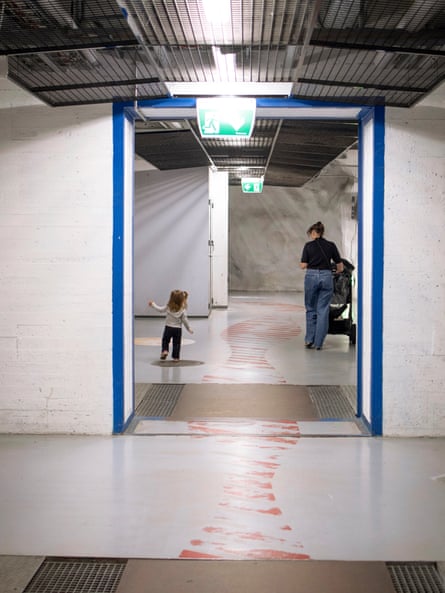 A mother and her child emerge from the Merihaka bunker in Helsinki.