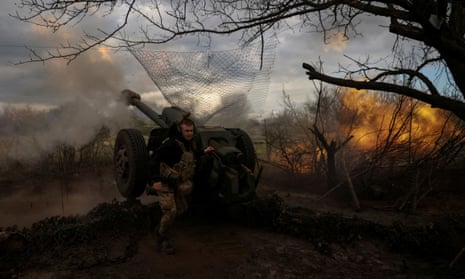 Ukrainian service members fire a howitzer D30 at a front line near Bakhmut.