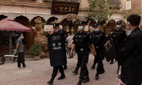 Police officers patrol in the old city in Kashgar, Xinjiang.