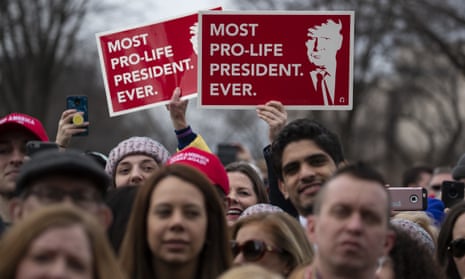 Anti-abortion marchers carry signs describing Donald Trump as 'Most pro-life president. Ever.'
