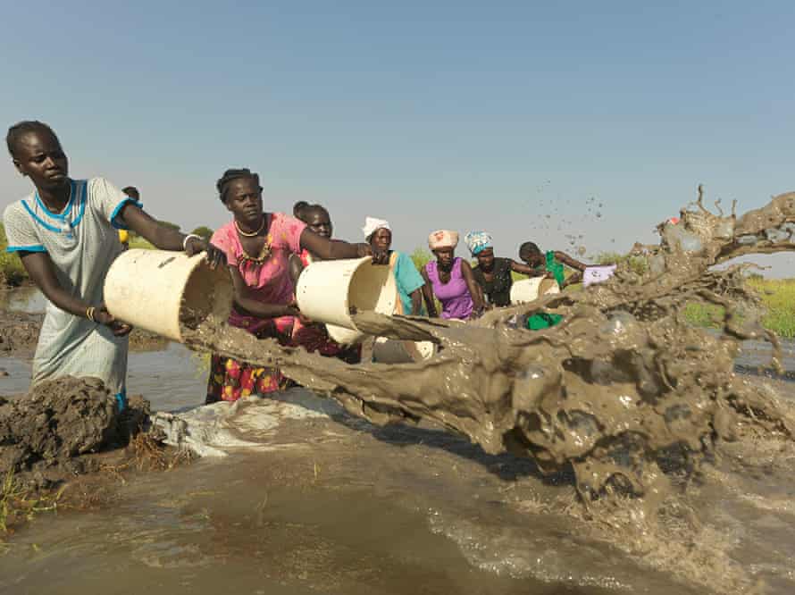 Women in Old Fangak volunteer to drain the flooded airstrip