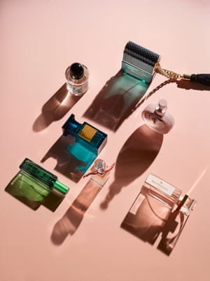 Bottles of perfume on a pink background