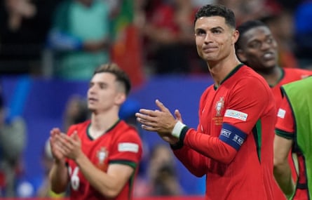 Cristiano Ronaldo leads his teammates in a round of applause for the Portugal fans after the match