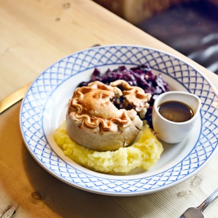 Main menu dish of steak and tangle foot pie served with creamy mash, Badger beer gravy and braised red cabbage at The Smugglers Inn, Osmington, Dorset, UK.