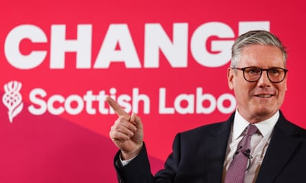 Keir Starmer points as he speaks, standing in front of a red backdrop saying ‘Change” Scottish Labour’