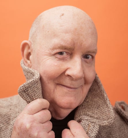 Head shot of George Hodson, against orange background, for a feature on five generations of gay men