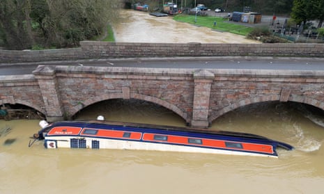 A narrowboat lays next to a road bridge over the River Soar after being swept away by flooding in the aftermath of Storm Henk.