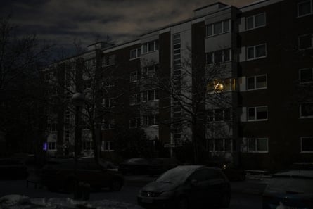 Block of flats at night with lights all off.