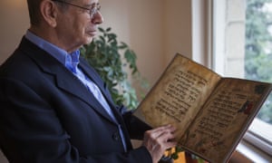 Eli Barzilai holds a copy of Haggadah