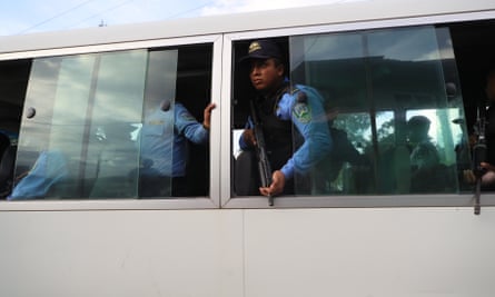 Police guard the prison where at least 46 were killed in a prison riot in Tegucigalpa, Honduras, on 20 June.