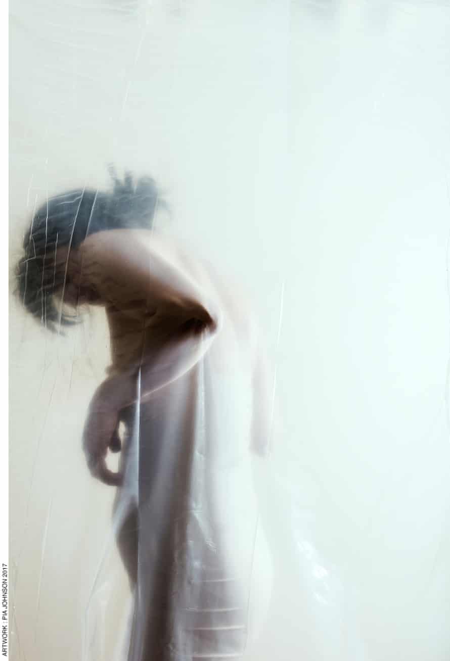 A woman behind a shower curtain